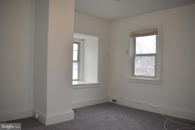 empty room featuring dark colored carpet