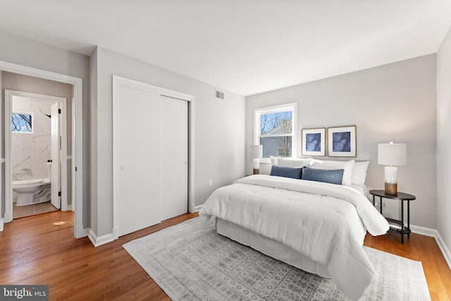 bedroom with wood-type flooring and a closet