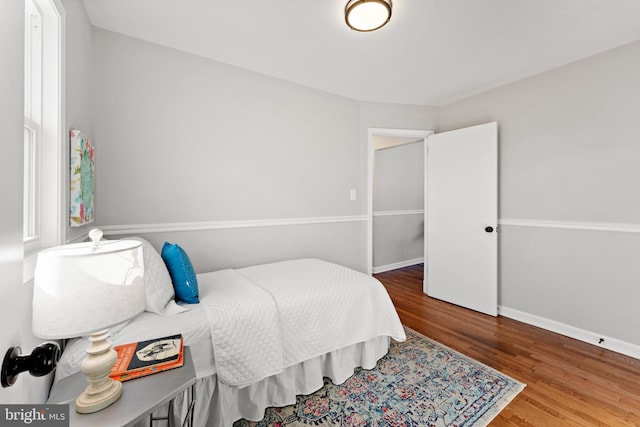 bedroom with hardwood / wood-style flooring