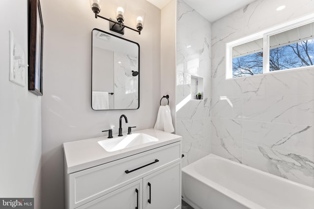 bathroom featuring vanity and tiled shower / bath combo