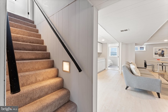 stairway with hardwood / wood-style flooring