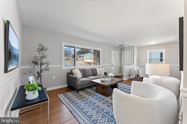 living room with a healthy amount of sunlight and dark hardwood / wood-style flooring