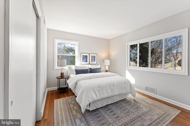 bedroom with dark hardwood / wood-style floors