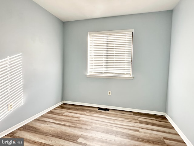 spare room featuring hardwood / wood-style floors