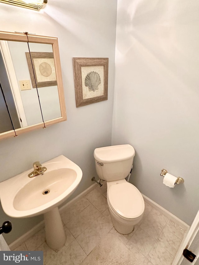 bathroom with tile patterned floors, toilet, and sink