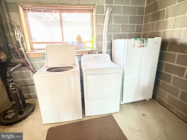 washroom with washing machine and clothes dryer