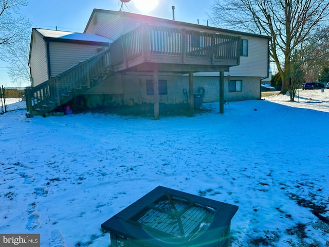 view of snow covered rear of property