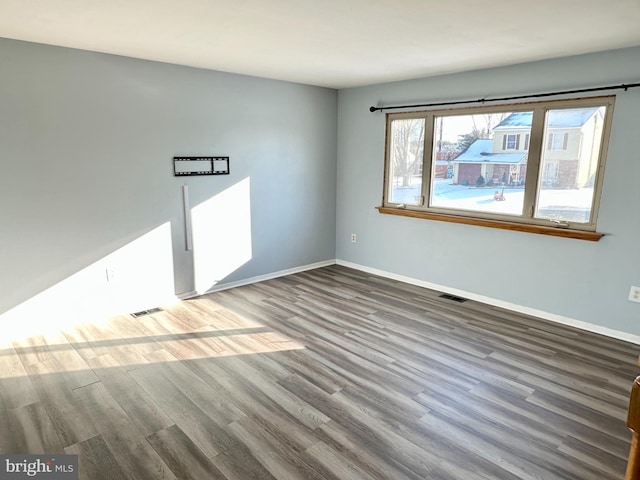 empty room featuring dark hardwood / wood-style flooring