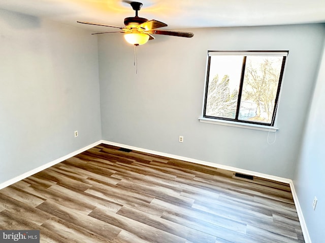 empty room featuring ceiling fan and light hardwood / wood-style flooring