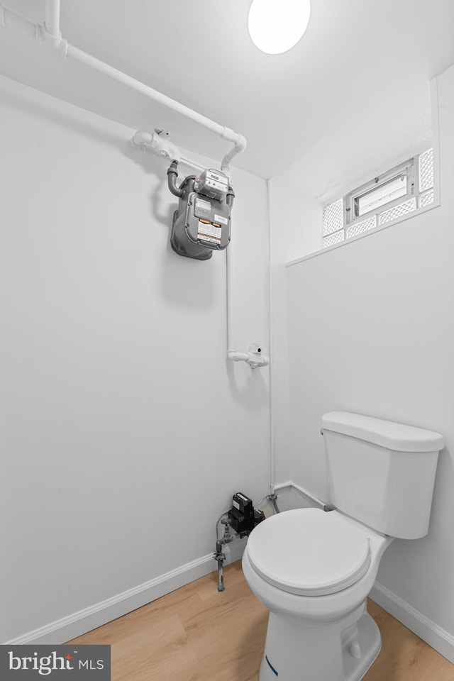 bathroom featuring hardwood / wood-style floors and toilet