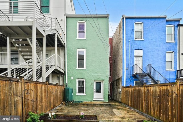 1324 Montello Ave NE, Washington, DC 20002 - rear view of house with stucco siding and a fenced backyard