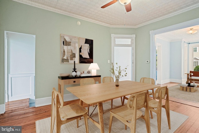 1324 Montello Ave NE, Washington, DC 20002 - dining room featuring plenty of natural light, light wood finished floors, a ceiling fan, an ornate ceiling, and ornamental molding