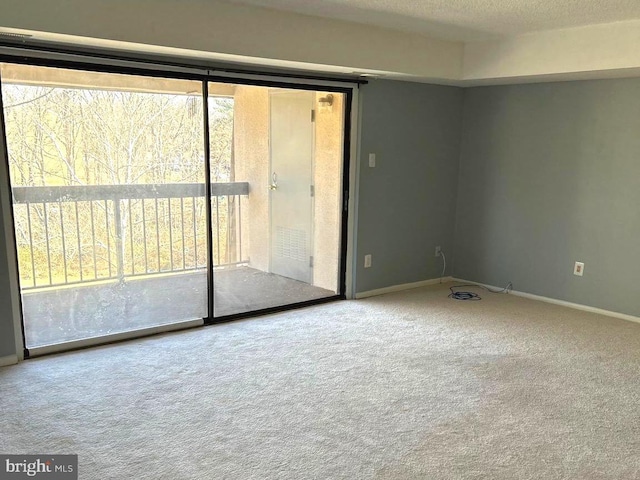 unfurnished room featuring a textured ceiling and carpet