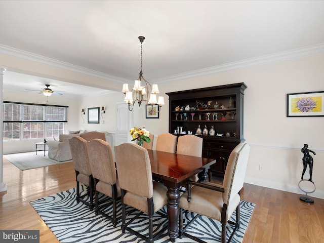 dining room with crown molding and light hardwood / wood-style floors