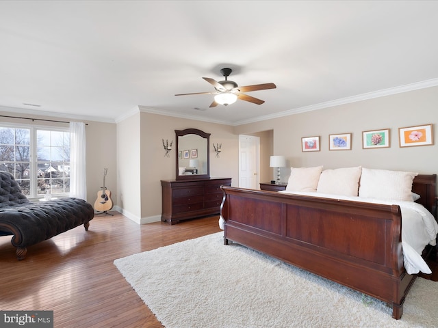 bedroom featuring ornamental molding, light hardwood / wood-style floors, and ceiling fan