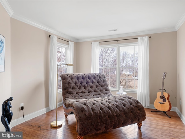 living area featuring crown molding and wood-type flooring