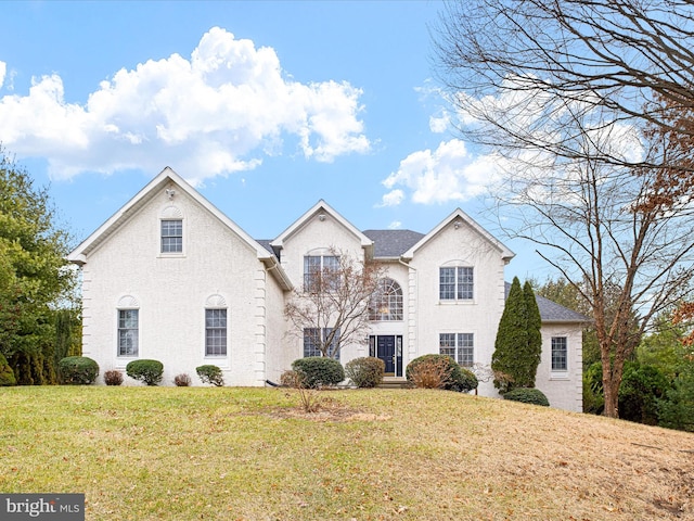 view of property featuring a front lawn