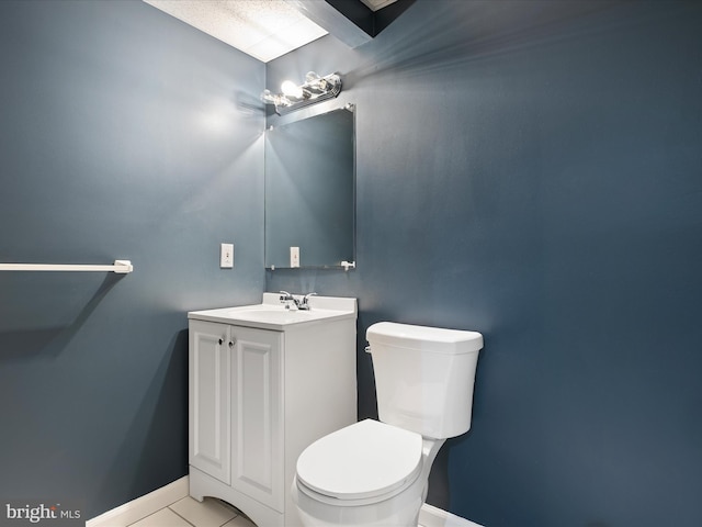 bathroom with vanity, tile patterned flooring, and toilet