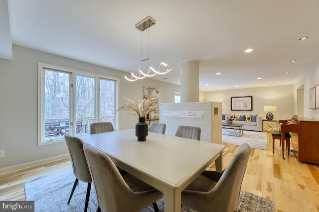 dining space featuring an inviting chandelier and light wood-type flooring