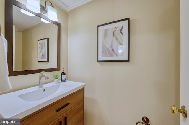 bathroom with crown molding and vanity