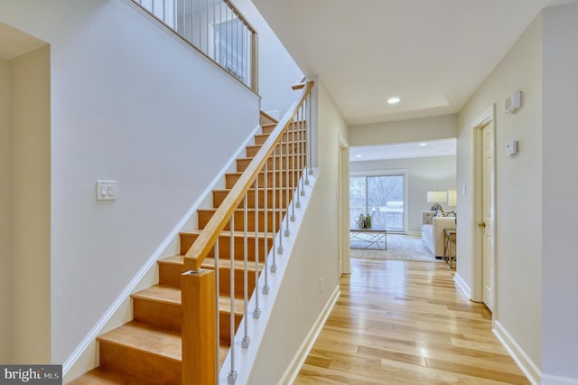 stairs featuring hardwood / wood-style floors