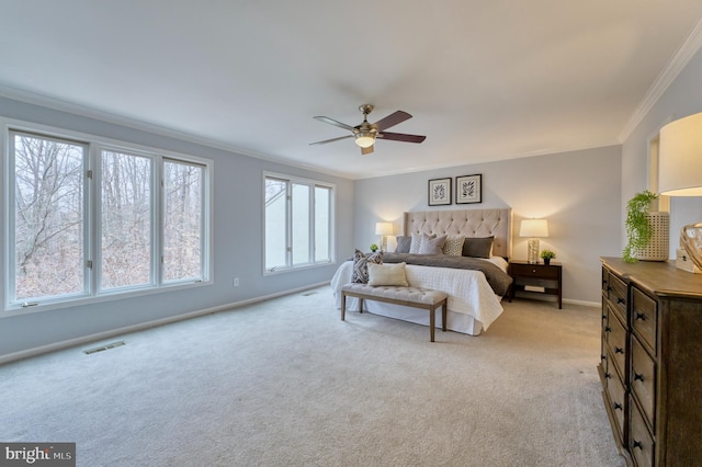 carpeted bedroom featuring ornamental molding and ceiling fan