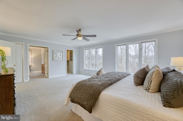 carpeted bedroom featuring ornamental molding and ceiling fan