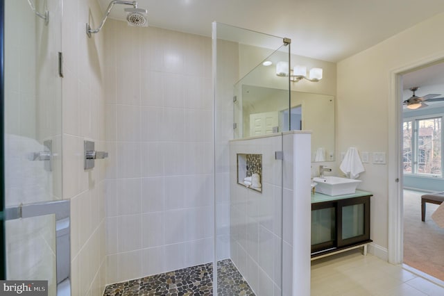 bathroom with vanity, ceiling fan, and tiled shower