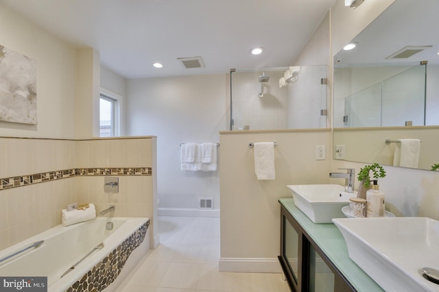 bathroom with vanity, tile patterned floors, and plus walk in shower