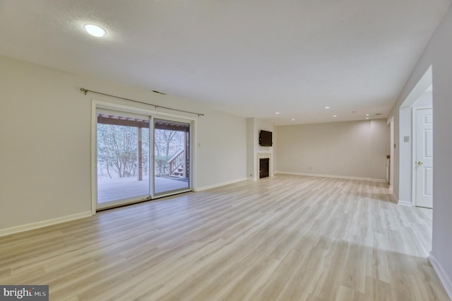 unfurnished living room featuring light wood-type flooring