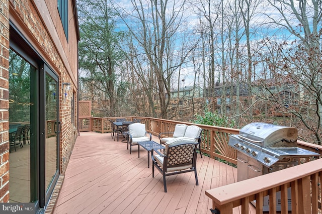 wooden deck featuring a grill and an outdoor hangout area