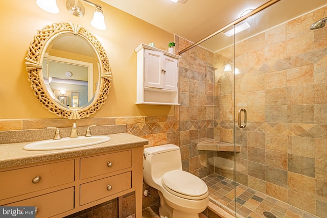 bathroom with vanity, toilet, and an enclosed shower