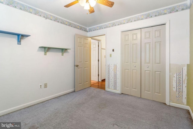 unfurnished bedroom with ceiling fan, light colored carpet, ornamental molding, and a closet