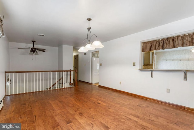 empty room featuring hardwood / wood-style floors and ceiling fan