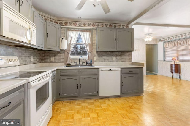 kitchen with gray cabinets, sink, white appliances, and light parquet floors