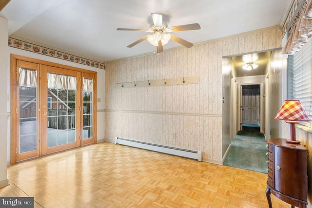 empty room with light parquet floors, a baseboard radiator, and ceiling fan