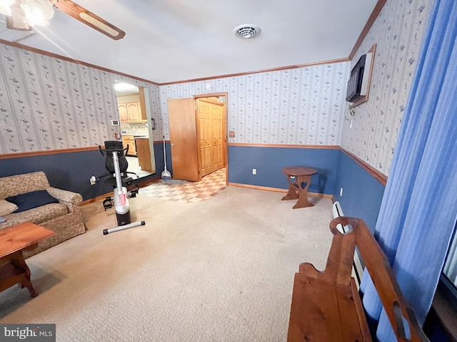 workout room featuring crown molding, carpet floors, a baseboard radiator, and ceiling fan