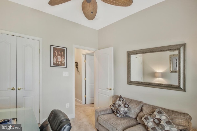 carpeted living room with ceiling fan