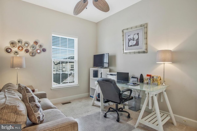 carpeted home office with ceiling fan