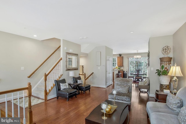 living room featuring dark hardwood / wood-style flooring and a notable chandelier