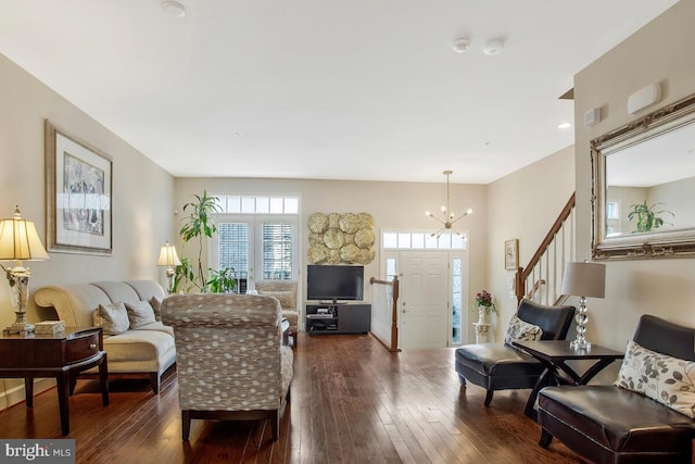 living room with an inviting chandelier and dark hardwood / wood-style floors