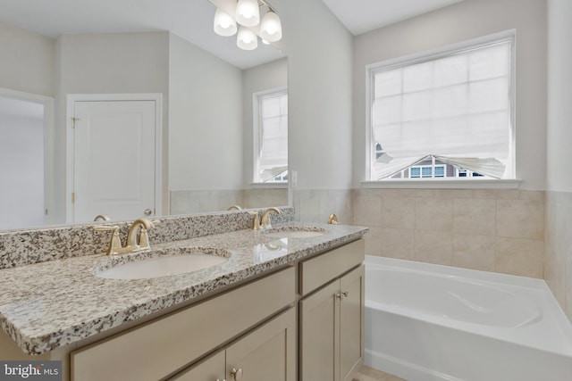 bathroom with vanity and a bath