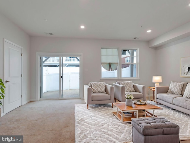 living room featuring plenty of natural light and light colored carpet