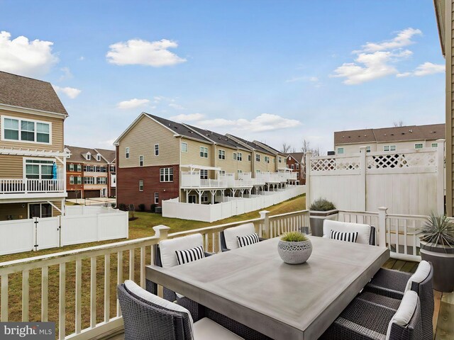 wooden terrace with a lawn