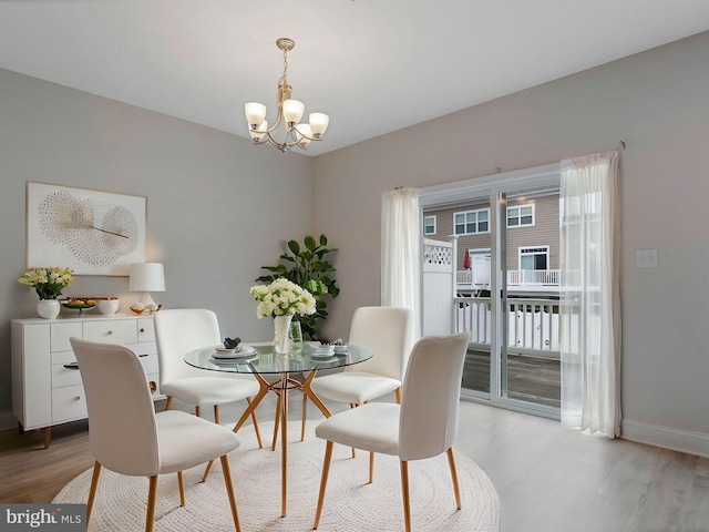 dining area featuring an inviting chandelier and light wood-type flooring