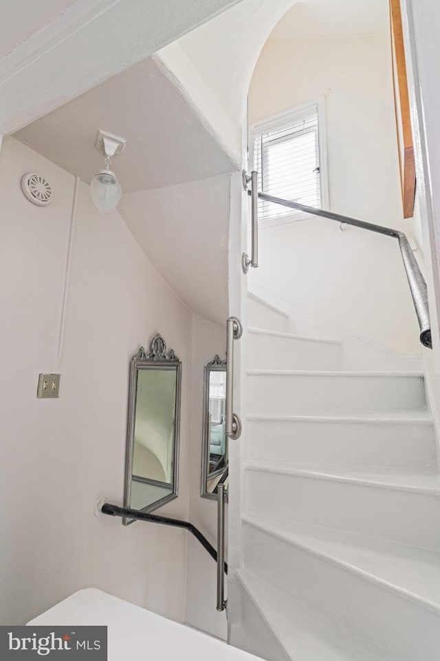 bathroom featuring lofted ceiling