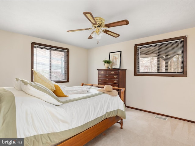 bedroom with light carpet and ceiling fan