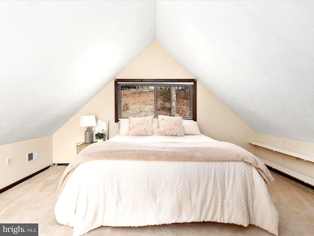 carpeted bedroom with vaulted ceiling