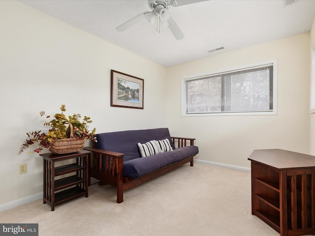 sitting room featuring light colored carpet and ceiling fan