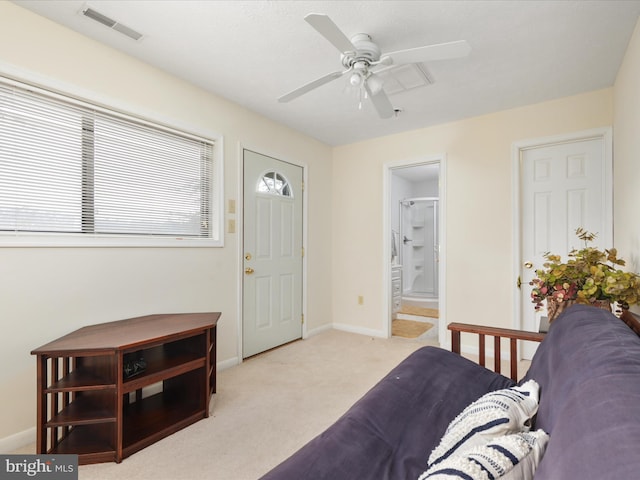 entryway featuring light carpet and ceiling fan